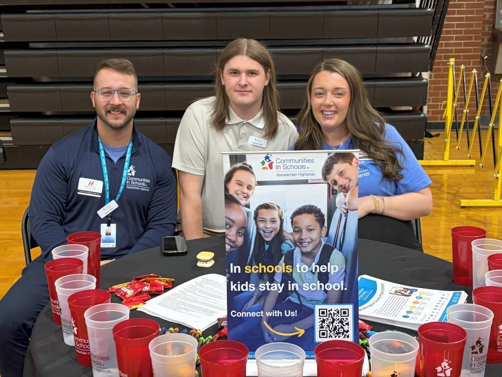 People representing an organization pose at a Career Fair.