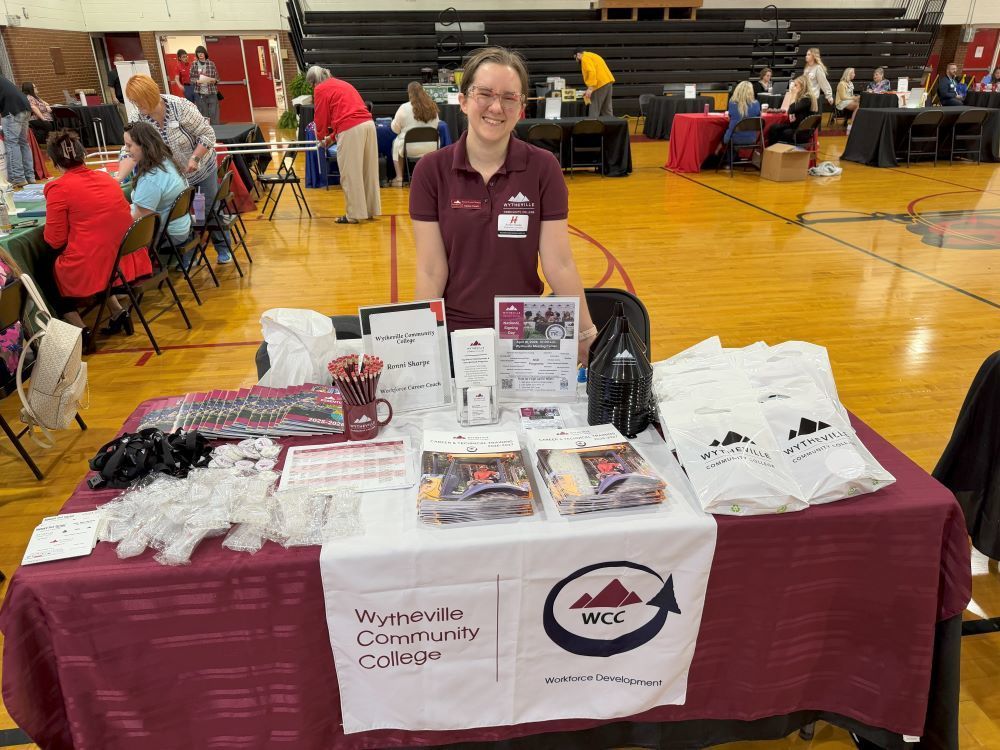 People representing an organization pose at a Career Fair.