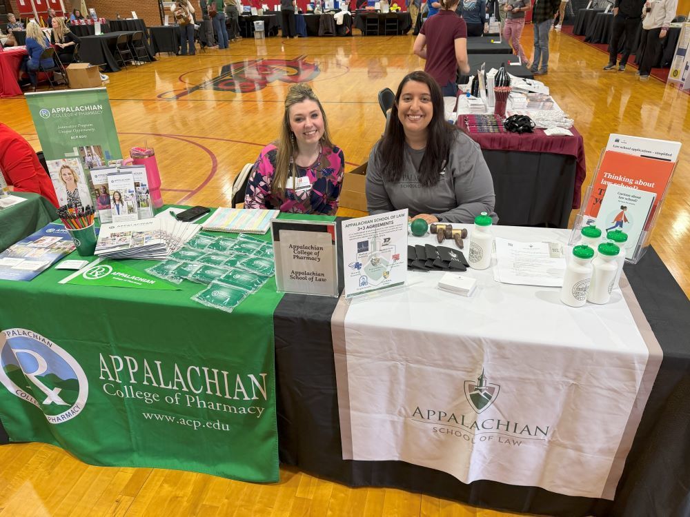 People representing an organization pose at a Career Fair.