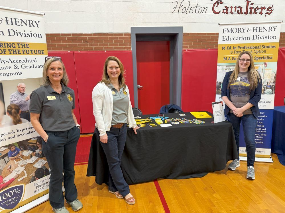People representing an organization pose at a Career Fair.
