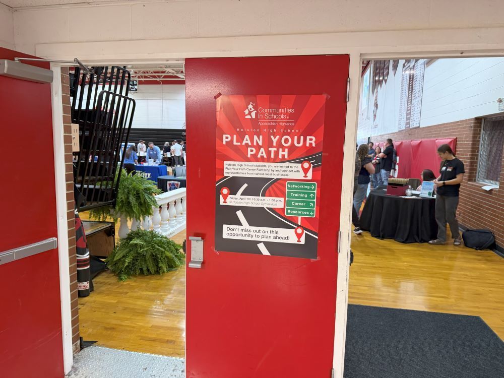 The Plan Your Path Career Fair sign is posted at the entrance to the Career Fair in the gym.