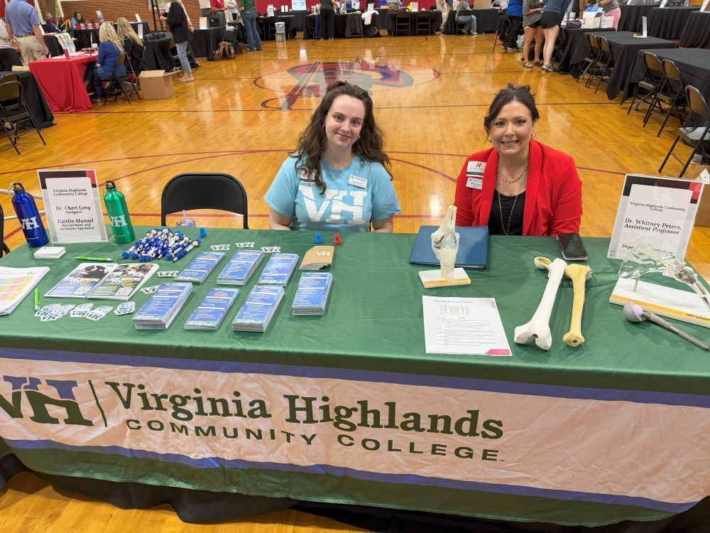 People representing an organization pose at a Career Fair.