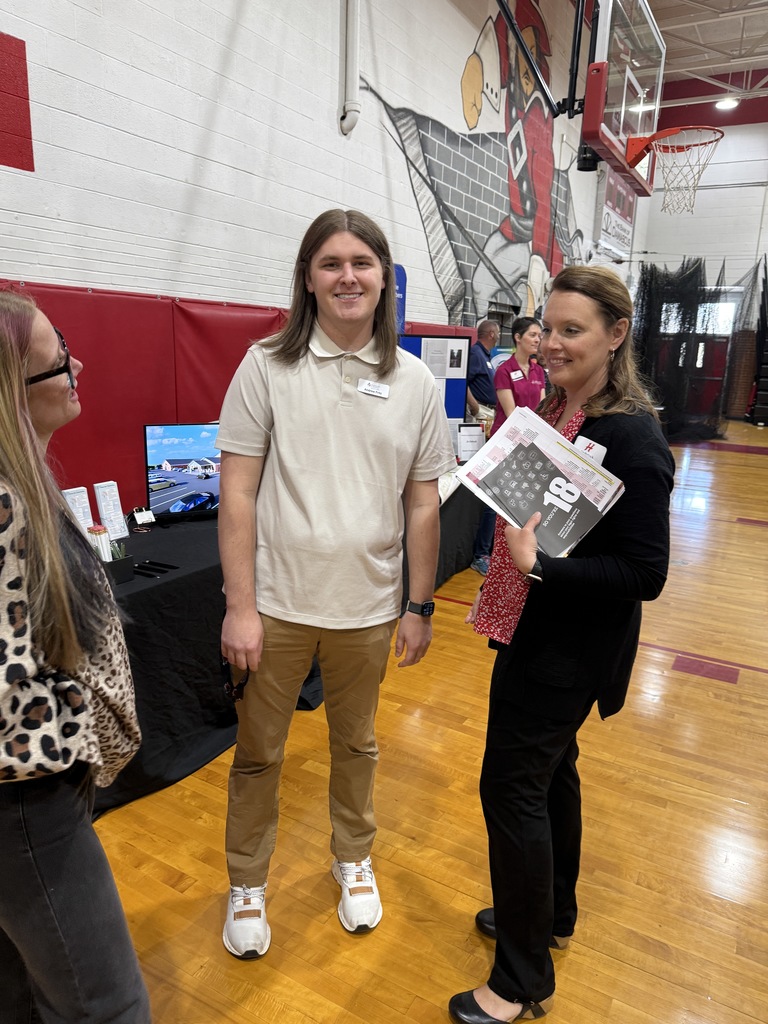 People representing an organization pose at a Career Fair.