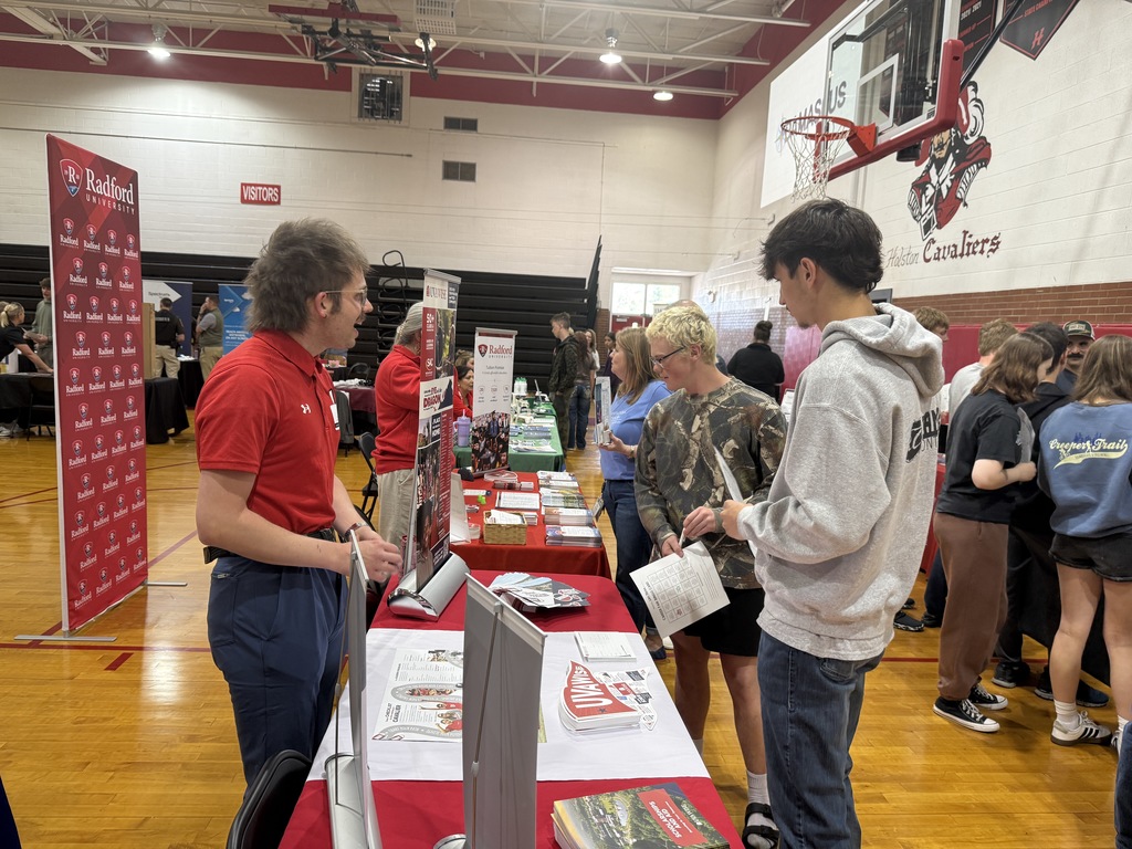 People representing an organization pose at a Career Fair.