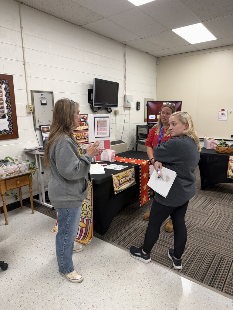 A teacher talks with other teachers in a PD session.