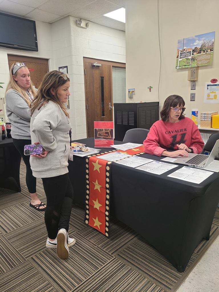 A teacher talks with other teachers in a PD session.