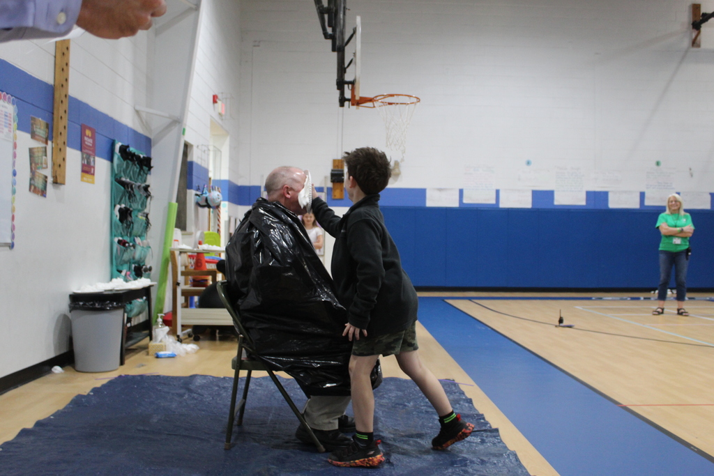 Student throwing pie at staff
