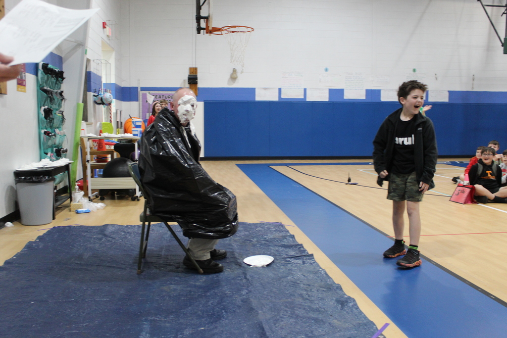 Student throwing pie at staff