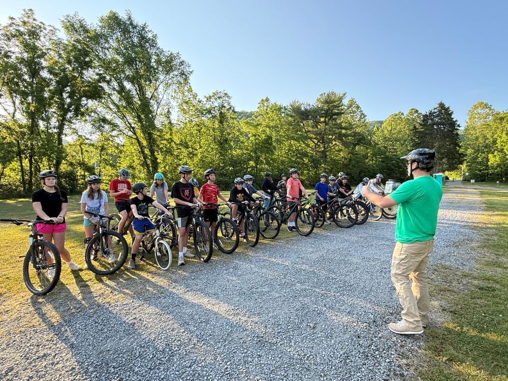 A man talks with a group of people on bikes.