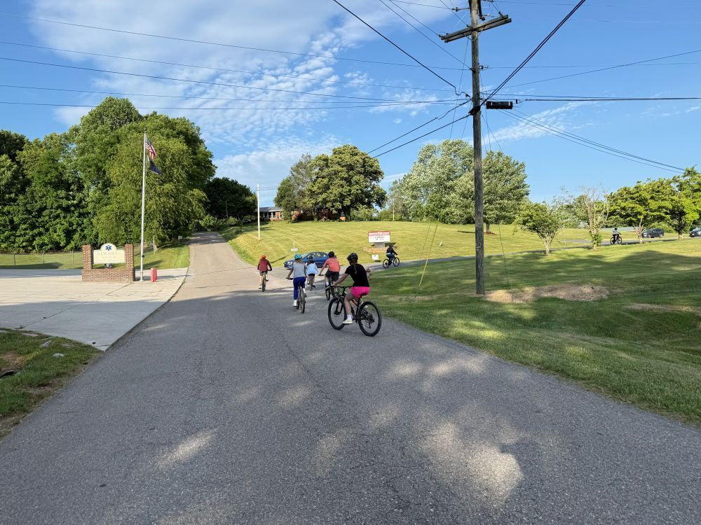 People ride bikes on a road.