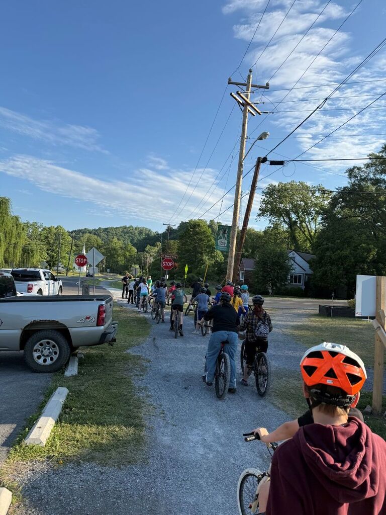 People ride bikes on a trail.