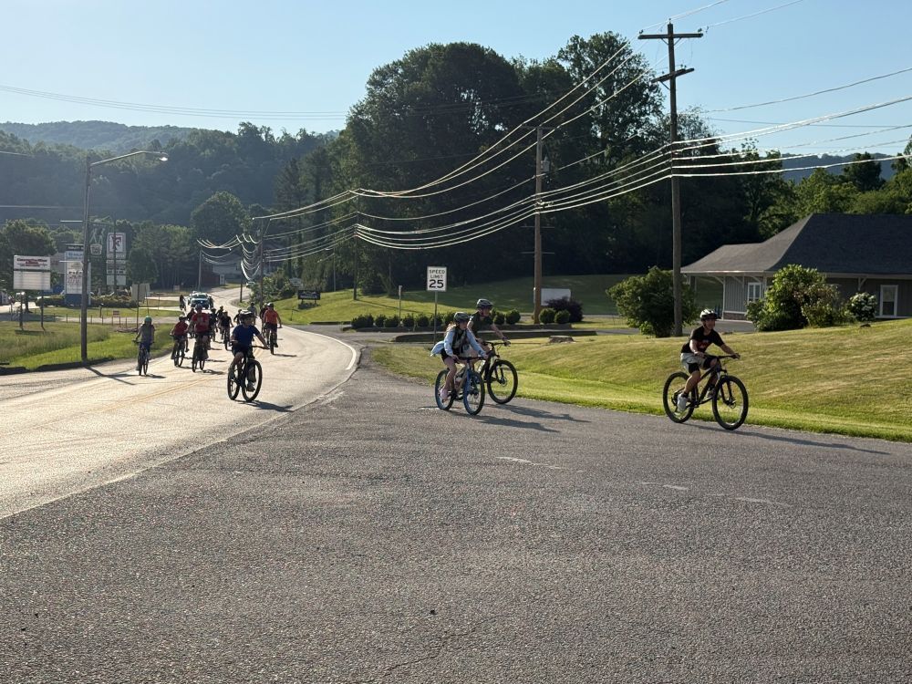 People ride bikes on a road.