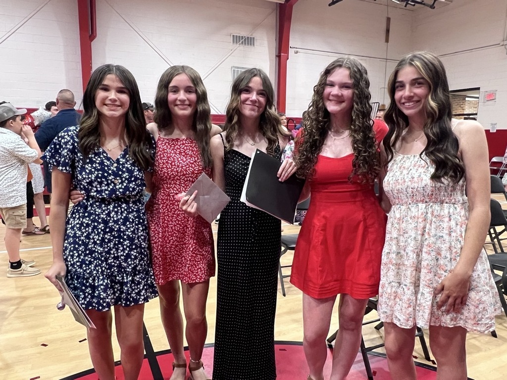 A group of students stand in a gym.