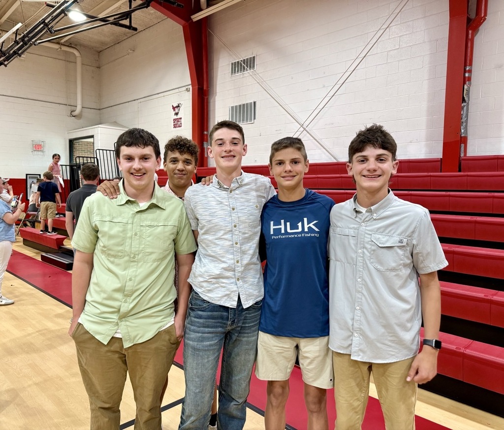 Students pose in a gym.