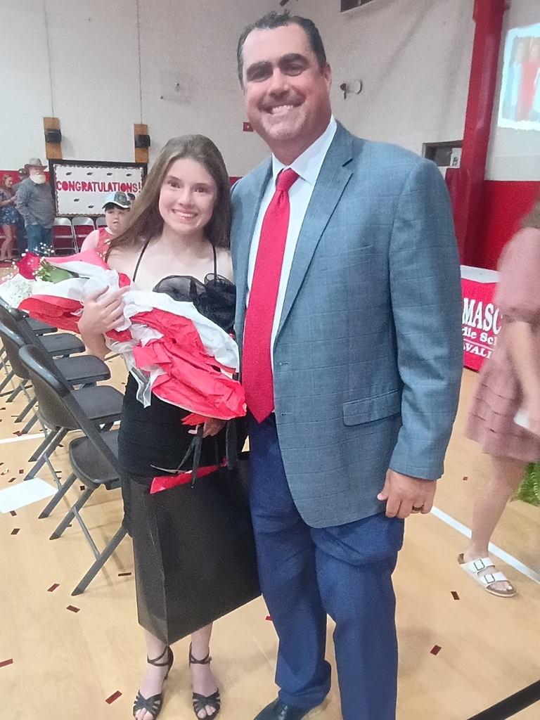 A student poses with a principal.