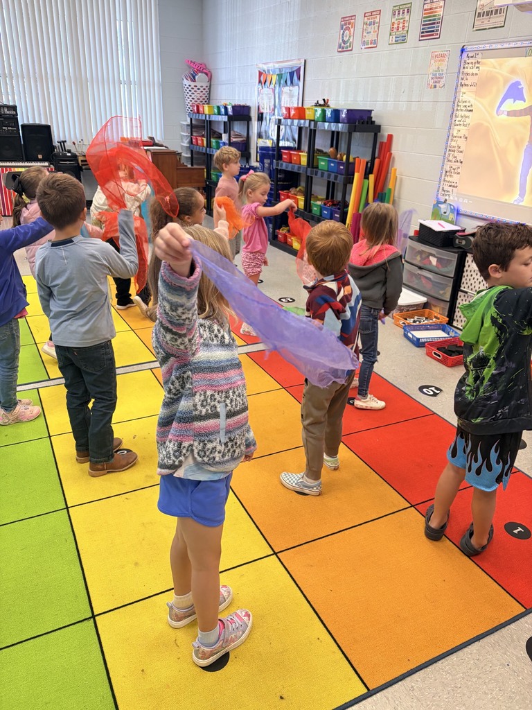 Ms. Morrows class moving scarves to the words of the song “ Blowing in the Wind”.