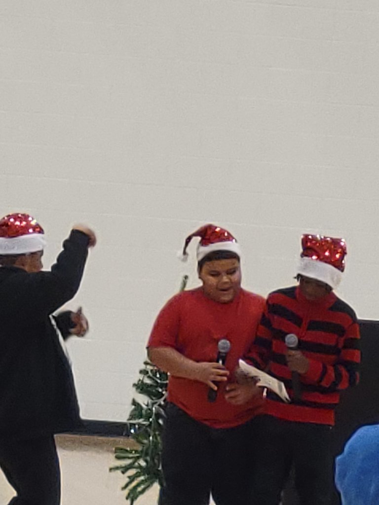 Mr. Magania dancing while students rap