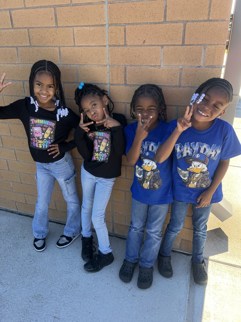 4 first grade students twinning outside.
