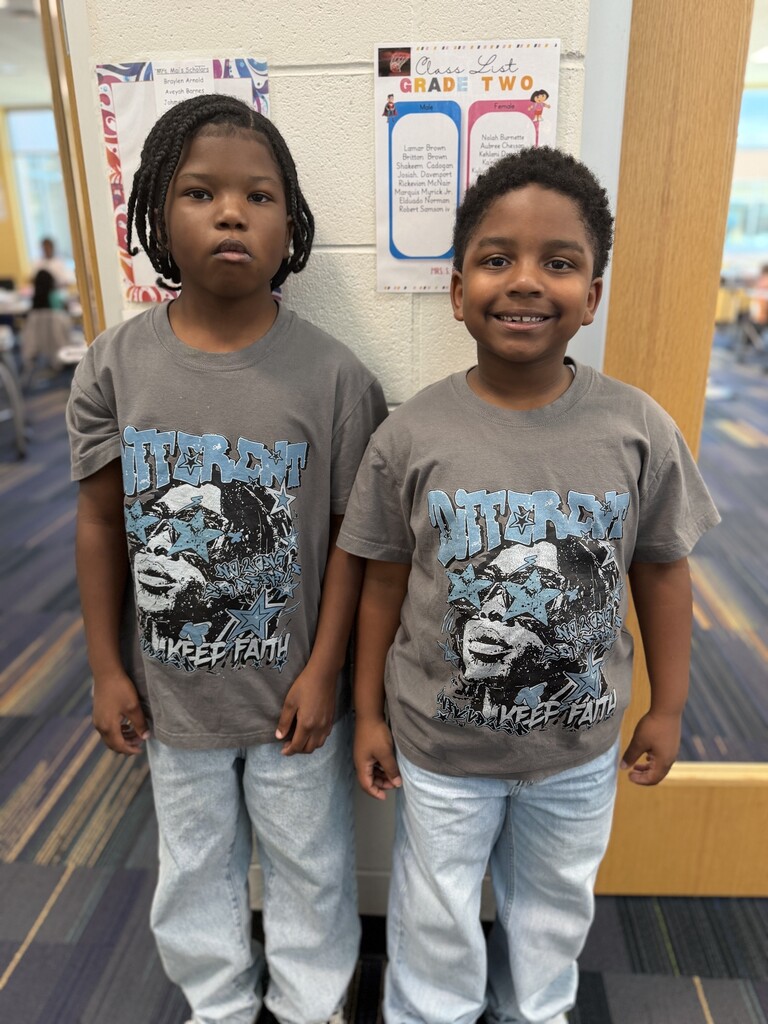 2 students wearing gray shirts and jeans.