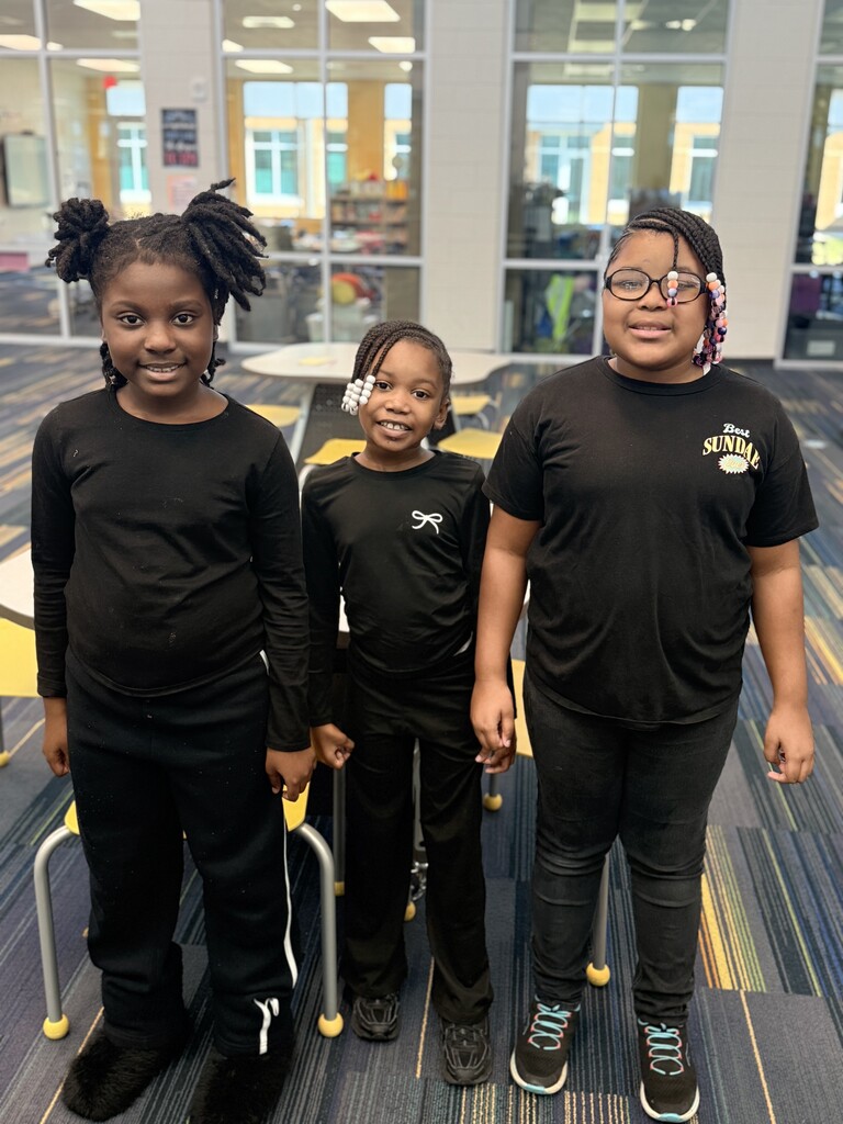 3 students wearing all black for twin day.