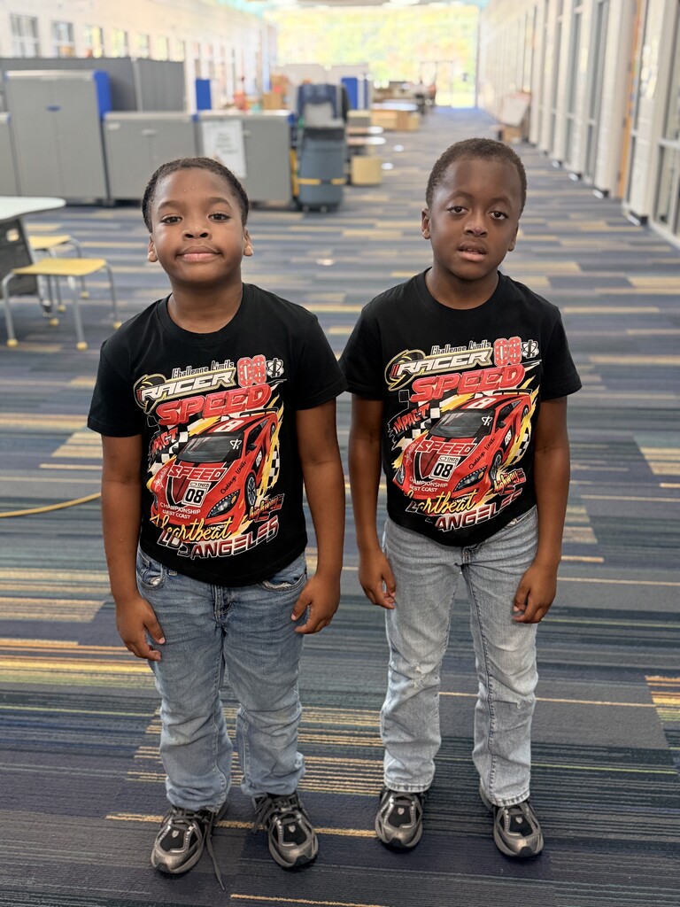 2 students wearing black shirts and jeans