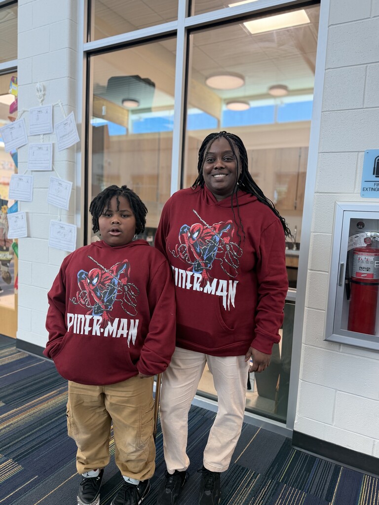 Ms. Walker and students wearing burgundy sweatshirt and tan pants.