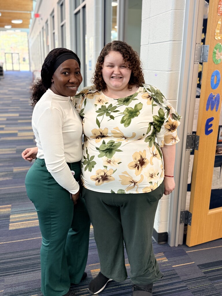 Mrs. Bennett-Francis and Ms. Houston wearing light colored tops and green pants.