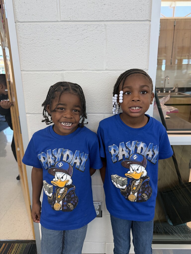 2 students twinning in blue shirts and jeans.