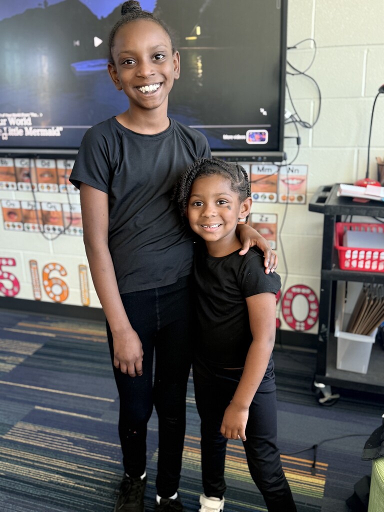 2 students wearing all black and twinning.