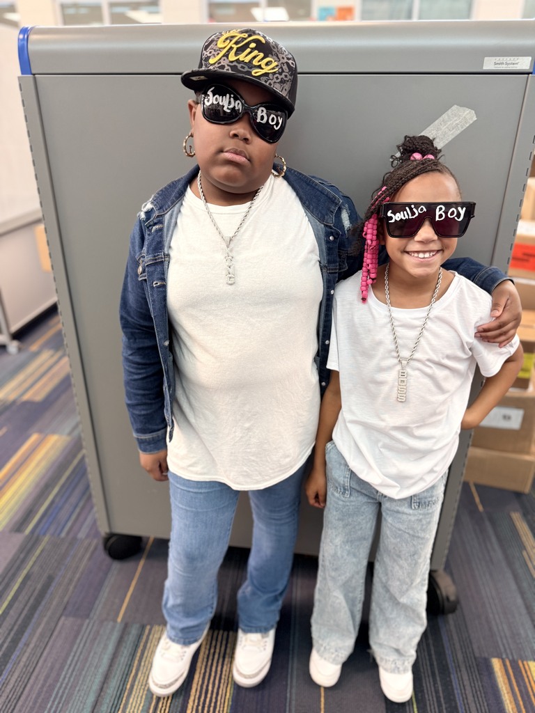 2 Siblings wearing Soulja Boy glasses, white shirts, and jeans.