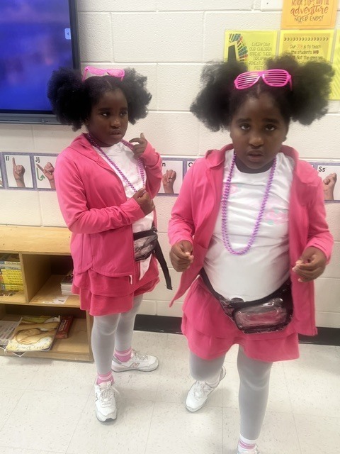 Twins twinning on decade day. Wearing pink from the 80's.