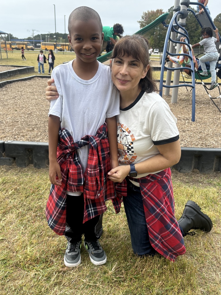 Mrs. Cordero and students matching for decade day.