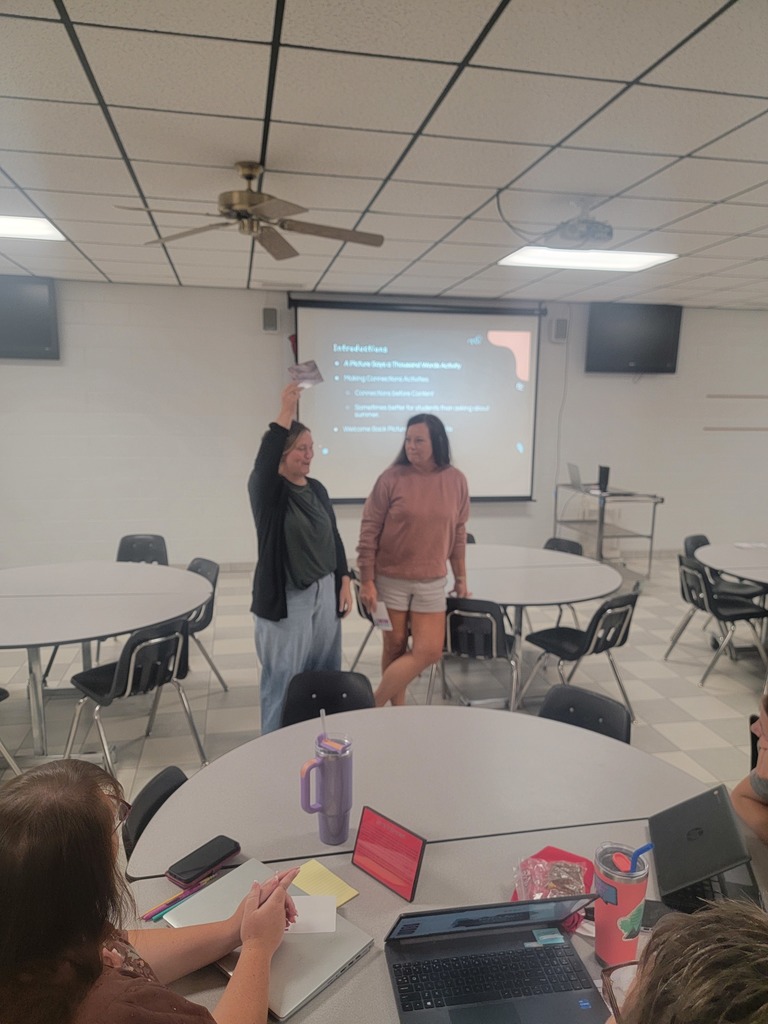WCES staff doing an activity with explaining a card