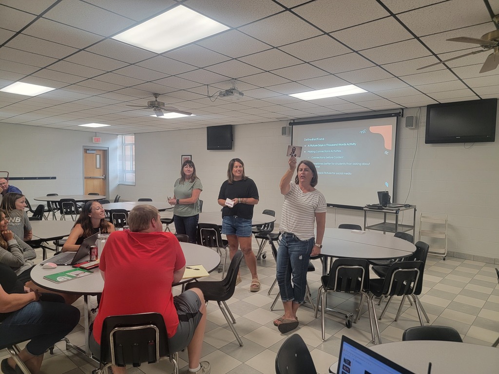 WCES staff doing an activity with explaining a card