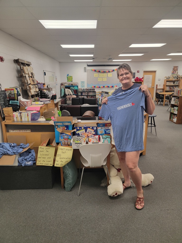 Traci Turner holds up a tshirt by her snacks