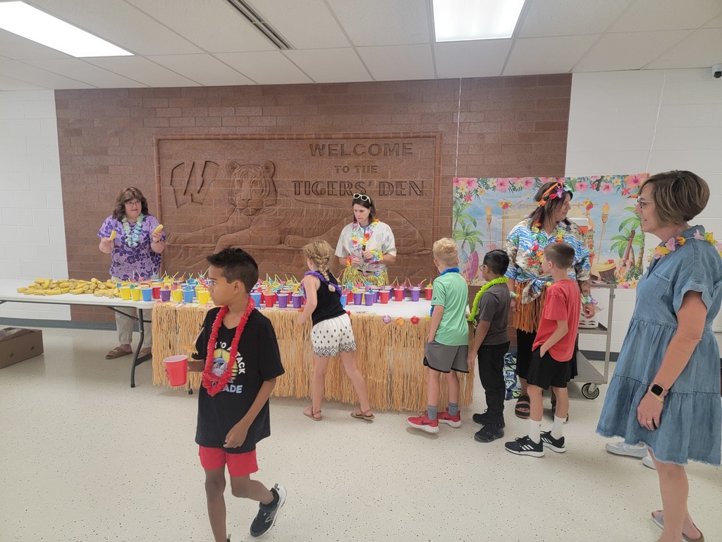 Kids getting a drink and a snack.