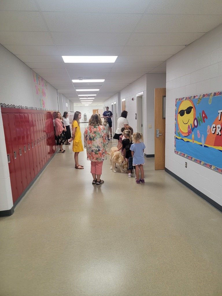 students and staff walking in hallway
