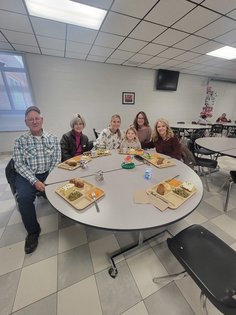 Students with December birthdays eating lunch with family and friends.