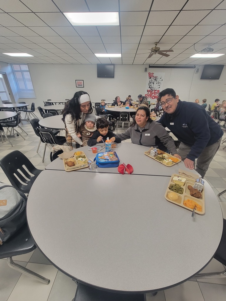 Students with December birthdays eating lunch with family and friends.