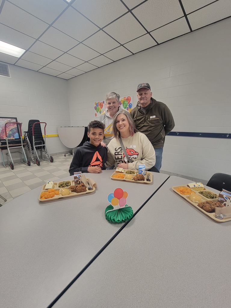 Students with December birthdays eating lunch with family and friends.