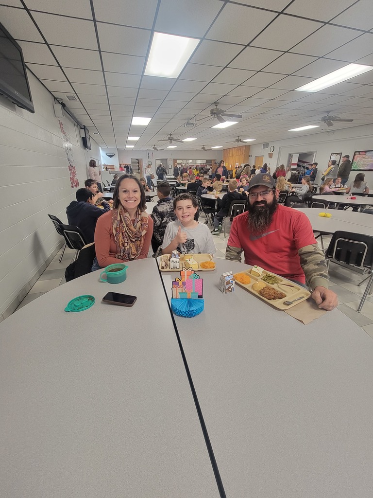 Students with December birthdays eating lunch with family and friends.