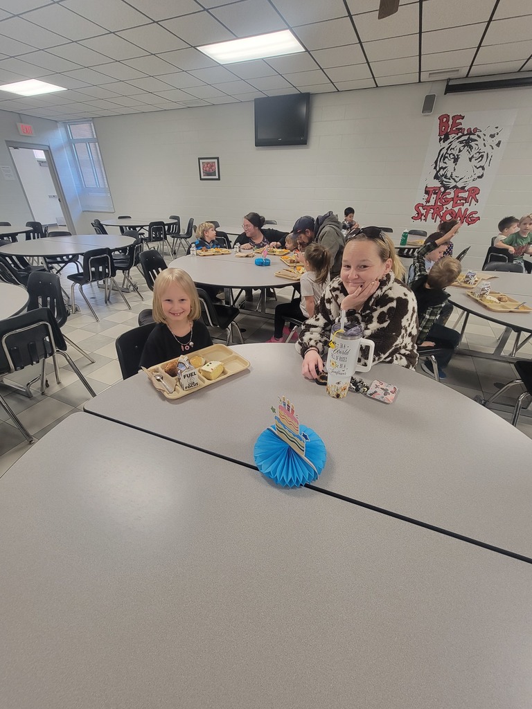 Students with December birthdays eating lunch with family and friends.