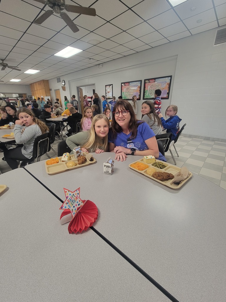 Students with December birthdays eating lunch with family and friends.