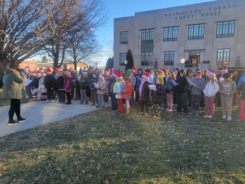 students caroling on courthouse lawn