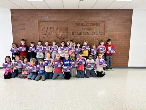 Elementary students showing off their new book.
