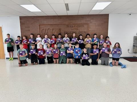 Elementary students showing off their new book.