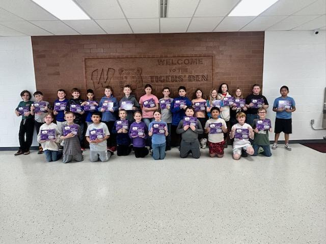 Elementary students showing off their new book.