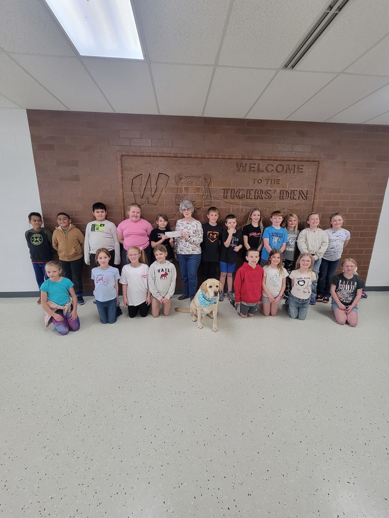 third grade presenting check to Jeanne Walker