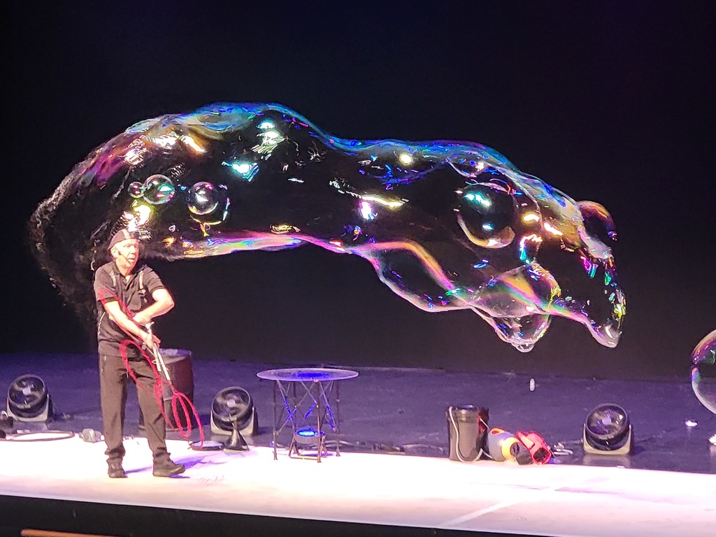 Man making a huge bubble.