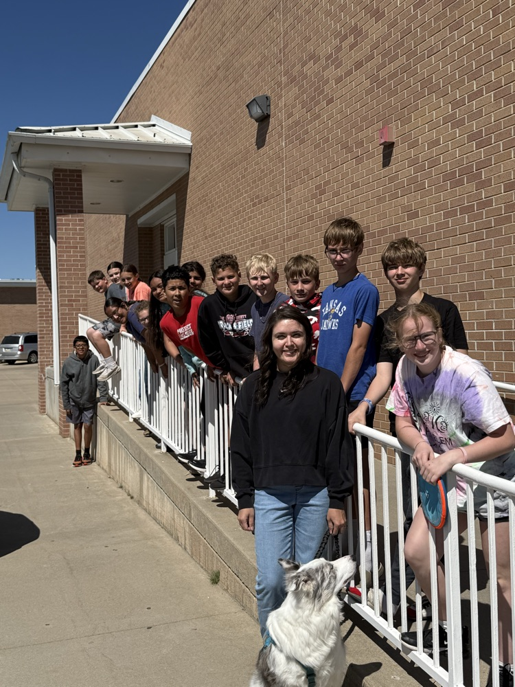 Loki poses with some of our 7th-grade students